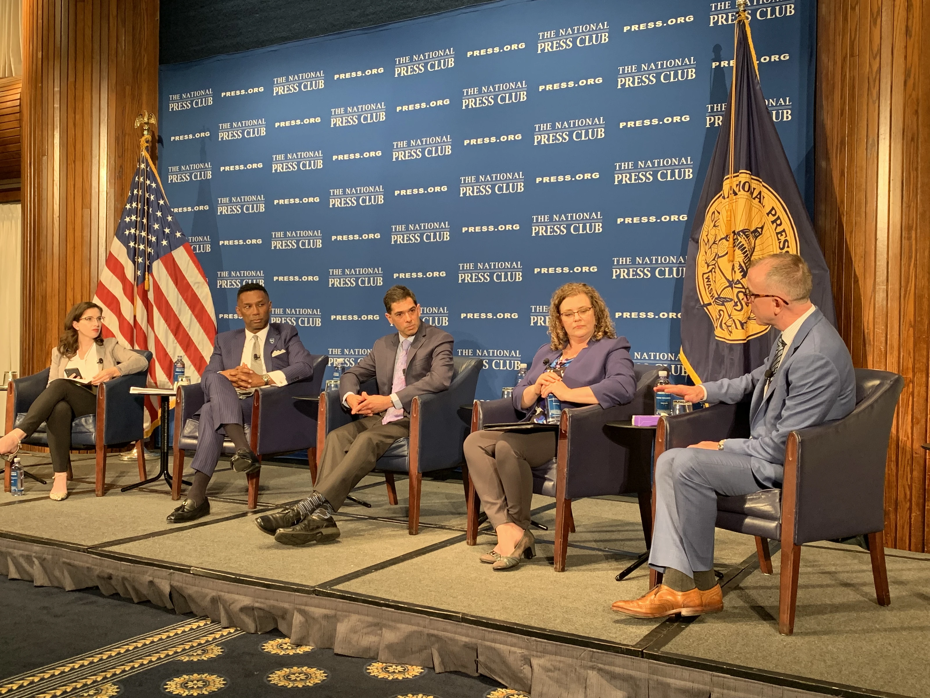 Panel discussion in front of national flags
