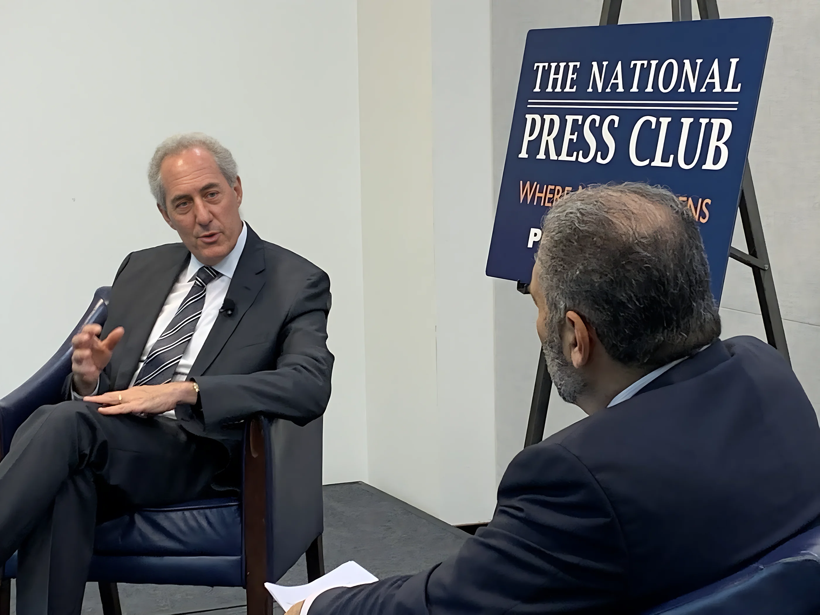 A client interviewed on stage at the National Press Club
